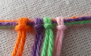 Knotting threads around the upper threads