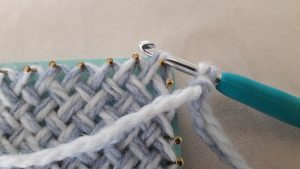 Crochet hook through the corner loop