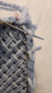 Insert needle into last stitch